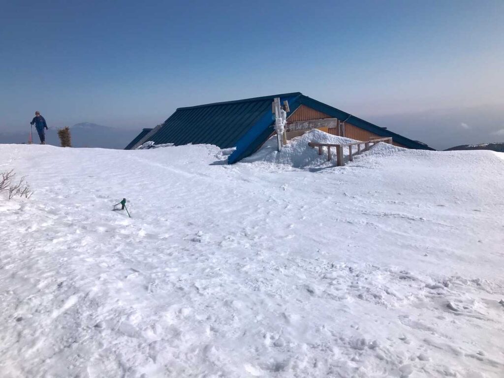 雪に埋もれた山頂標識