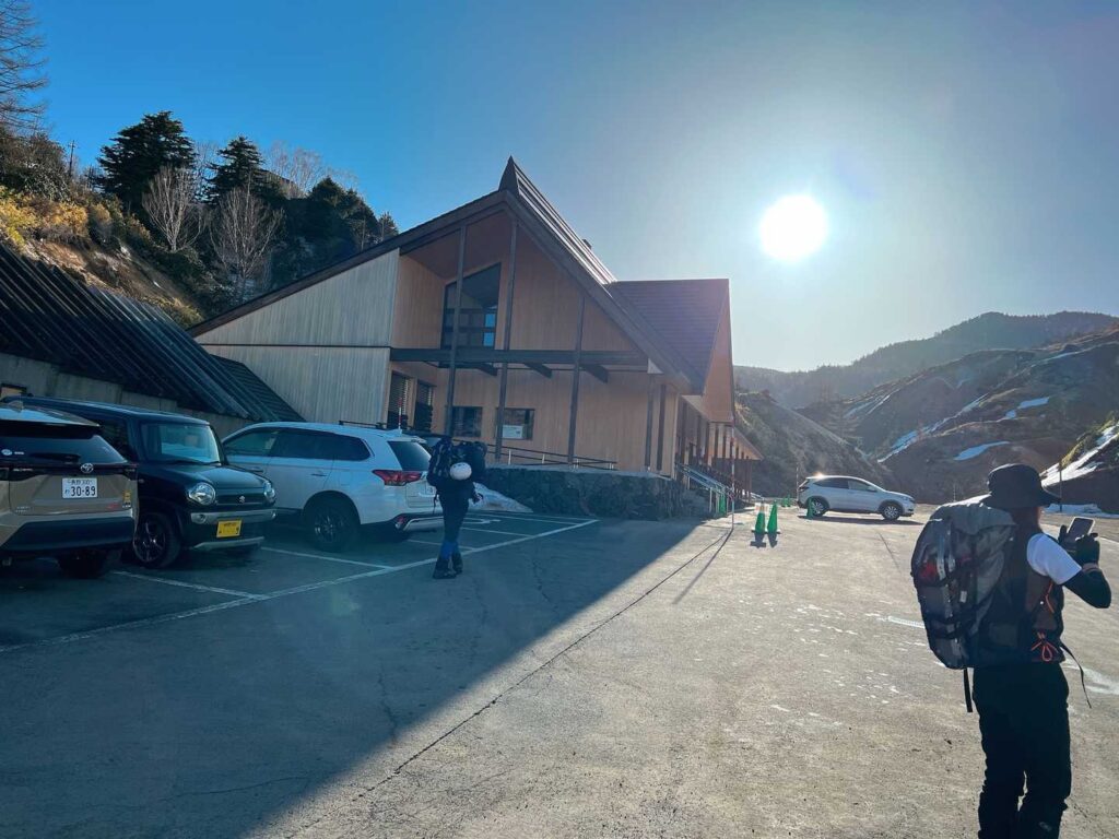 万座自然情報館の駐車場。朝6時半でも余裕で停められた